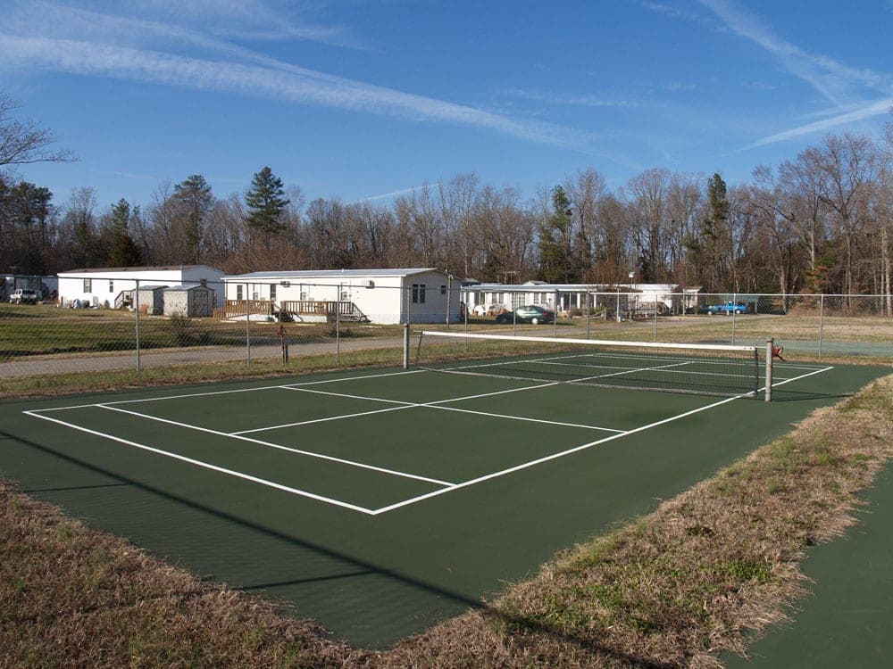 Tennis and court with net on a sunny day