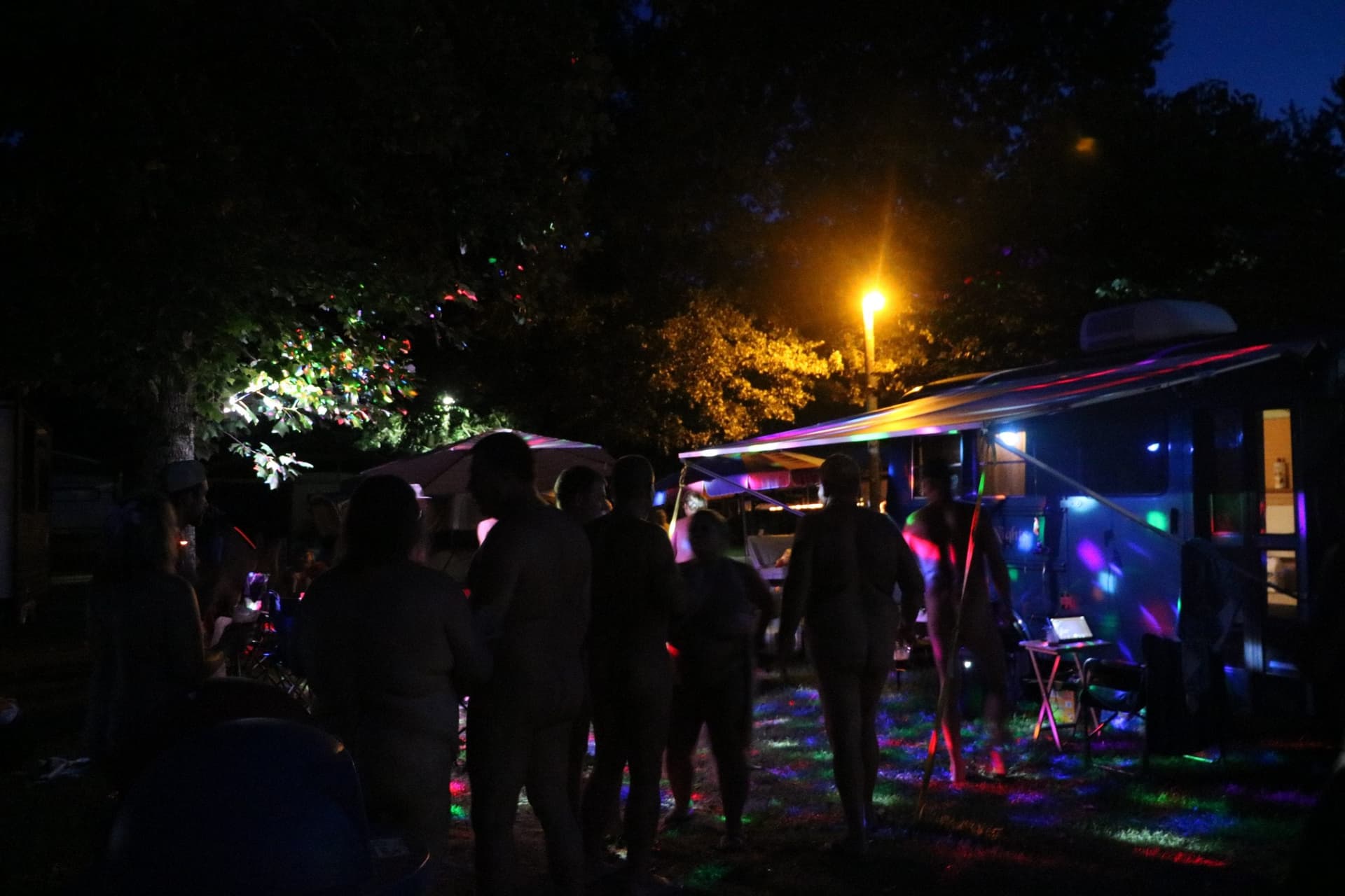 RV campsite illuminated with string lights at night