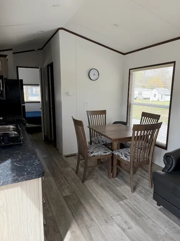 Park model dining area with wooden table and chairs